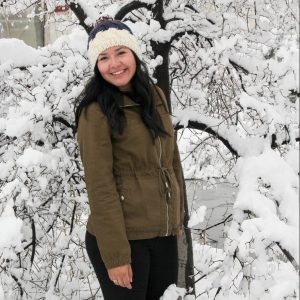 April Cano in front of snow covered tree
